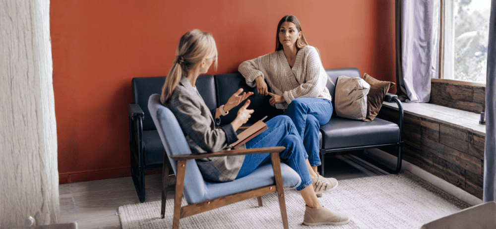 Therapist and client sitting down talking