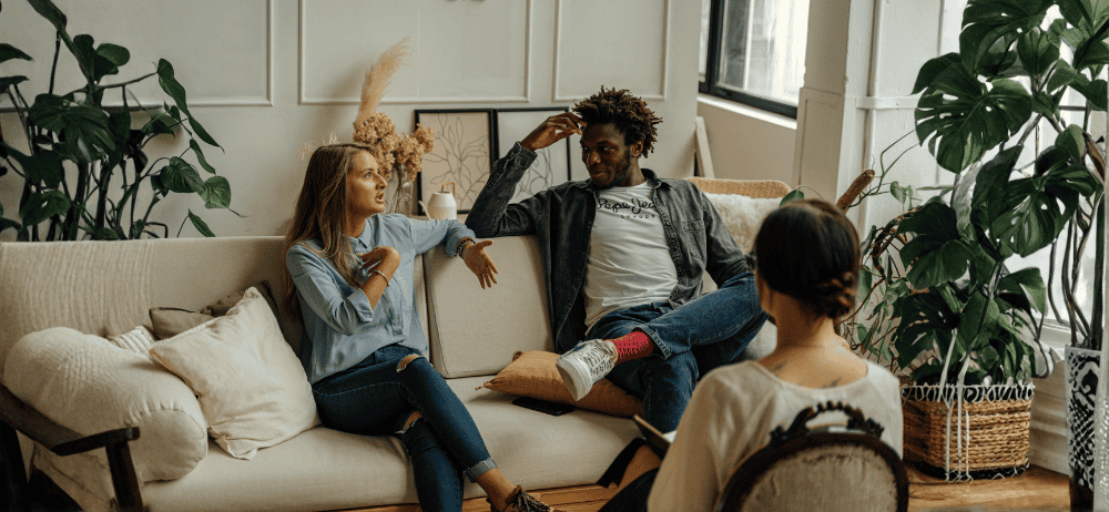 Therapist sitting with couple while couple engages in conversation