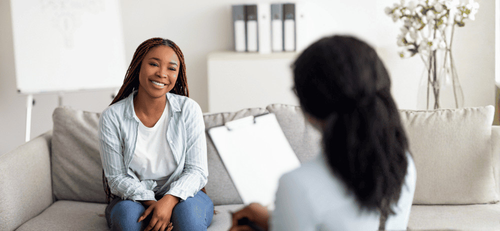 Therapist sitting with happy client